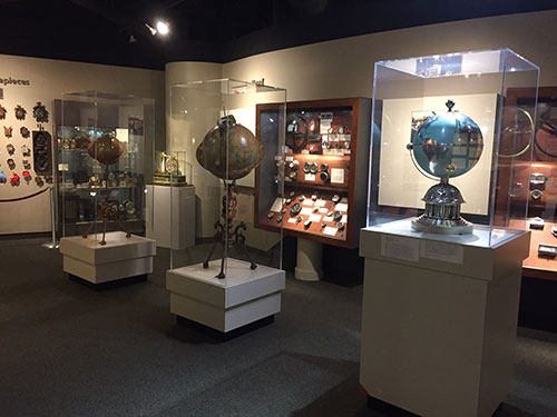 Photo of three time globes with novelty and car clocks in background